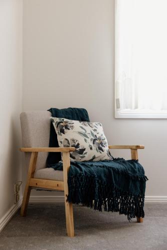 a chair with a pillow on it in a room at Mountains Reach in Bowral