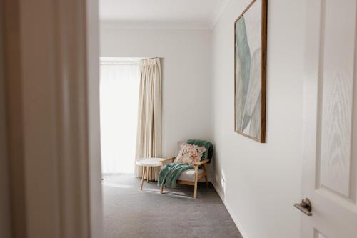 a living room with a chair and a window at Mountains Reach in Bowral