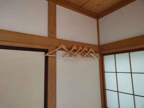 a group of hangers in a room next to a window at 4BRHouse near Nikko Suginami Cedar Avenue in Nikko