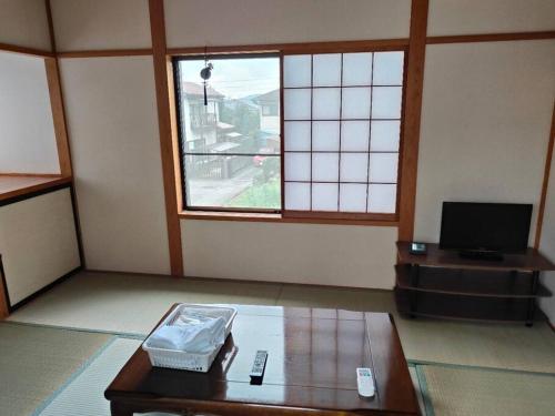 a living room with a table and a tv at 4BRHouse near Nikko Suginami Cedar Avenue in Nikko