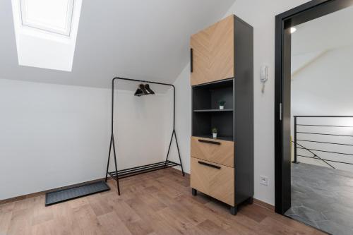 a room with a closet with a dresser and a mirror at Apartmány Stříbrná Liška in Jáchymov