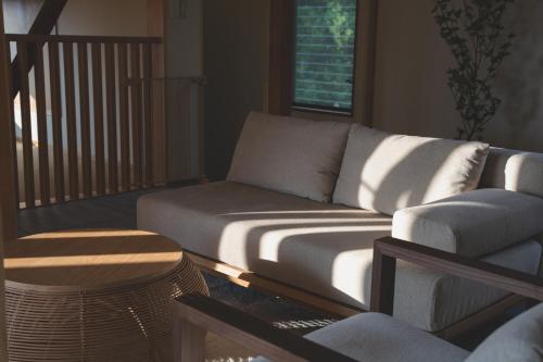 a living room with a couch and a table at プライベートリゾート伊豆 in Izunokuni