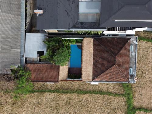an overhead view of a house with a pool on the roof at Bubble Villa & Rice field view in Kerobokan