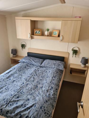 a bedroom with a bed in a small room at 127cs HOBURNE NAISH HOLIDAY PARK in Highcliffe