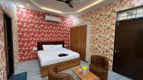 a bedroom with a bed and a table and chairs at Casa bella a beautiful house in Chittaurgarh