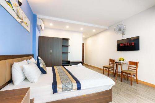 a hotel room with a bed and a table at Green Airport Hotel in Ho Chi Minh City