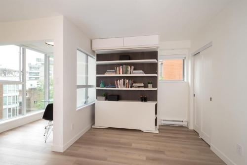 a room with a book shelf and a desk at Executive Studio in Vancouver
