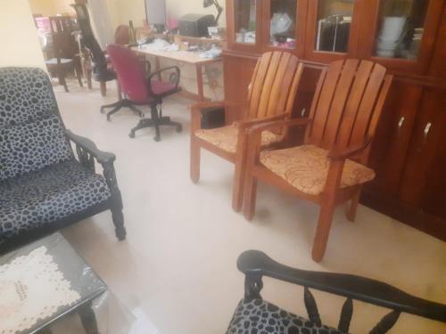 a living room with two chairs and a table at Star villa dehiwala in Kalubowila West