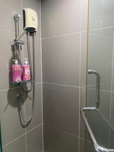 a bathroom with a shower with two shampoo bottles at Centrio Condominiums Top Floor with Pool and Garden view in Ban Na Khua