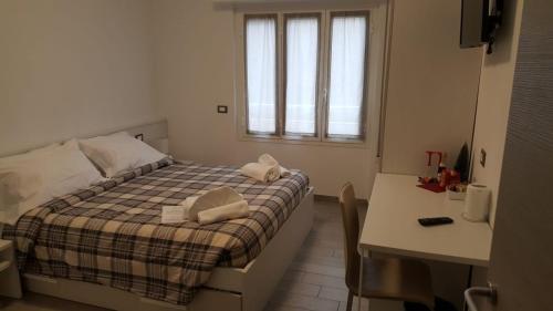 mała sypialnia z łóżkiem i stołem w obiekcie Albergo Aduepassi & Servizio Bike Shuttle w mieście Finale Ligure
