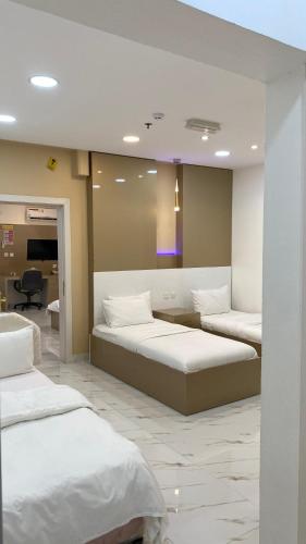 a bedroom with two beds in a room at Marina in Sohar