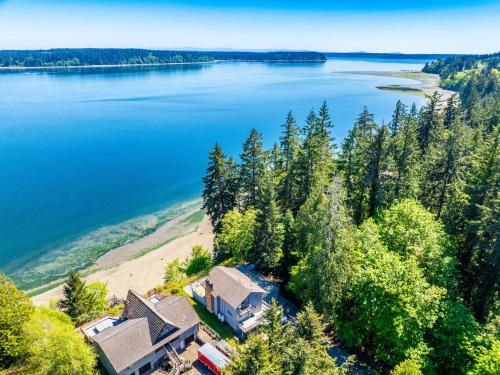 an aerial view of a house on the shore of a lake at Oceanfront Retreat, Mount Rainier, King bed, Games in Longbranch