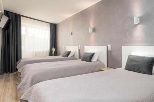 Voodi või voodid majutusasutuse Hotel Vesiroos toas