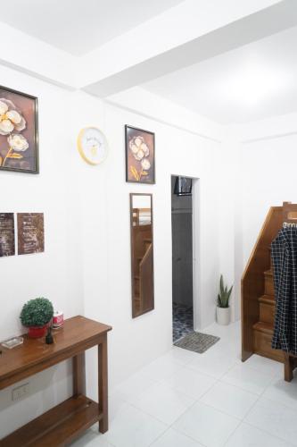 a white room with a table and a mirror at Shelves Siargao in General Luna
