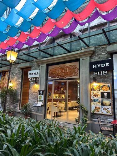 a restaurant with purple and purple umbrellas over the door at Cozy 5pax AndroidTVBOX Free Parking WiFi 1U PJPAC in Kampong Bukit Lanjan