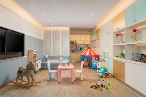 a childs room with a play room with a tent at Mövenpick Myth Hotel Patong Phuket in Patong Beach