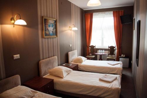 Posteľ alebo postele v izbe v ubytovaní Hotel Nad Rzeczką