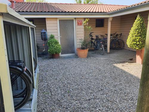 a house with bikes parked outside of it at Haus Achtern Diek in erster Reihe am Meer in Fehmarn