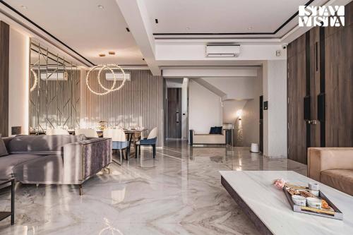 a lobby of a hotel with a dining room at StayVista at Grande Prima - Pool, Theatre Room & BBQ in Panchgani