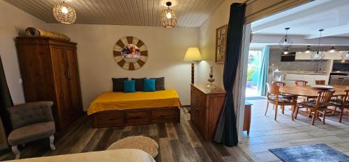a bedroom with a bed and a dining room at Tiare Pool Lodge in Pirae