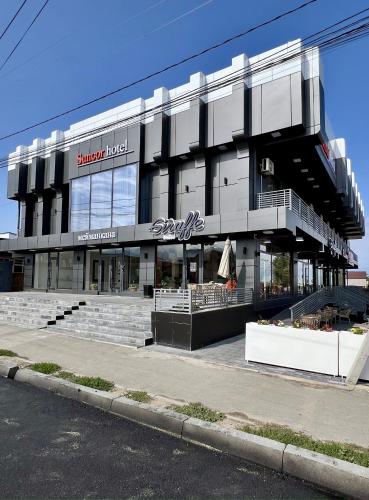 a store front of a building on a street at Suncor Hotel in Karakol