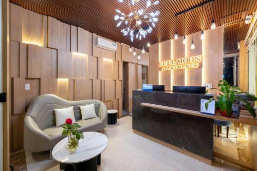 a lobby of a building with a chandelier at Full Moon Apartments & Villa - Hoi An in Hoi An