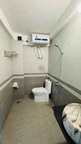 a bathroom with a white toilet and a sink at Sapa Harmony Homestay in Sapa