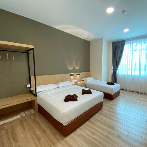 Ένα ή περισσότερα κρεβάτια σε δωμάτιο στο Kaia Suite Semporna