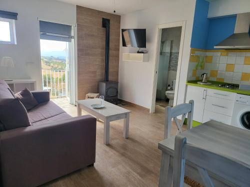 a living room with a couch and a table at La Jaima in Prado del Rey