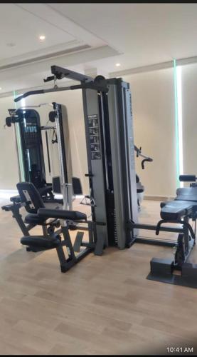 a gym with several tread machines in a room at Studio Apartment at Leela Residencies. in Bengaluru