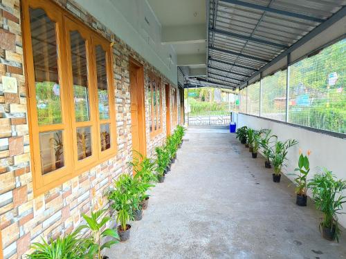 a hallway with potted plants on the side of a building at Travelmate Vagamon in Vagamon