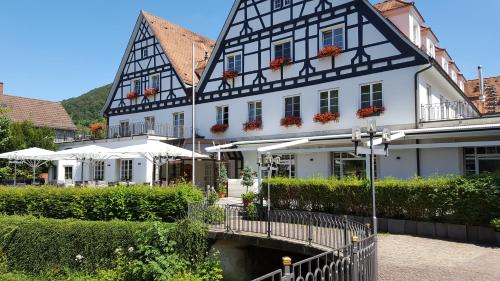 a black and white building with a bridge in front of it at Bad Hotel Bad Überkingen in Bad Überkingen
