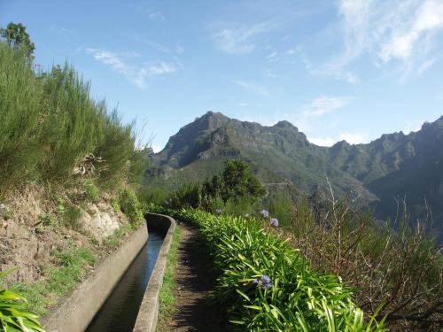 a canal of water with mountains in the background at Apartment Palma Madeira wandern und tauchen in Caniço