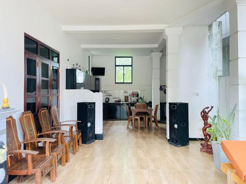 a kitchen and dining room with chairs and a table at Peacock Villa in Welihinda