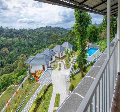 an aerial view of a house with a swimming pool at Le Serene Munnar Luxury Resorts & Spa in Ūdumbanshola