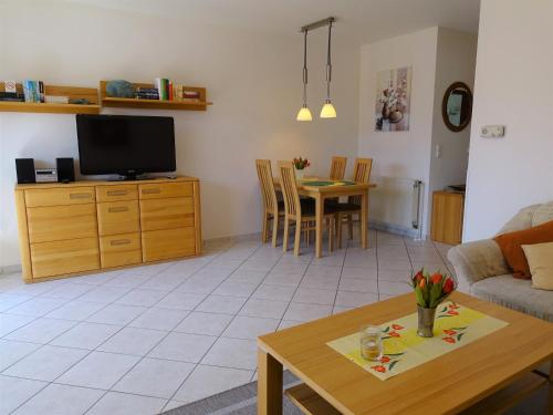 a living room with a couch and a table at Nachtigall 2 in Grönwohldshorst