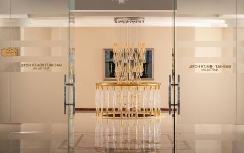 a chandelier in the middle of a room at Gashalti Health Hotel Naftalan in Naftalan