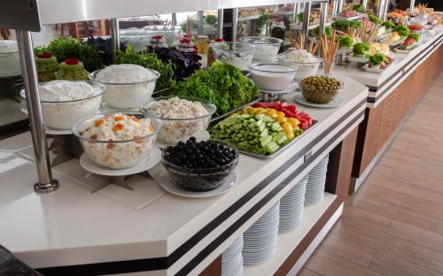 a buffet line with bowls and plates of food at Gashalti Health Hotel Naftalan in Naftalan