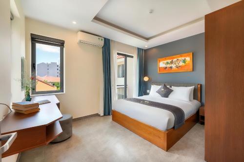 Postel nebo postele na pokoji v ubytování Full Moon Apartments & Villa - Hoi An