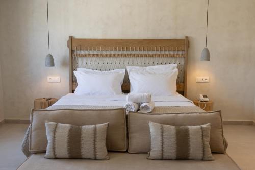 a bedroom with a large bed with two pillows at Aerostay Mykonos in Mýkonos City