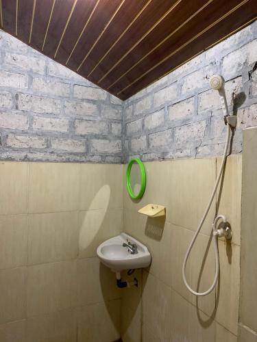 a bathroom with a sink and a shower at Bamboo Lombok Homestay in Kuta Lombok
