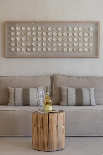 a bottle of wine and a glass on a table at Aerostay Mykonos in Mýkonos City