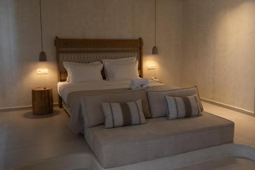 a bedroom with a large bed with two pillows at Aerostay Mykonos in Mýkonos City