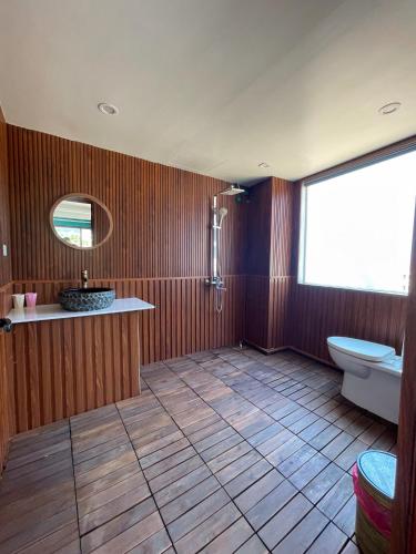 a bathroom with a toilet and a sink and a mirror at D Home Sapa in Sapa
