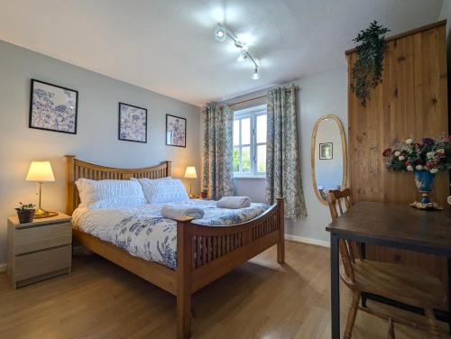 a bedroom with a bed and a table and a mirror at City Centre Vintage Theme Guest Rooms Free Parkin in Liverpool