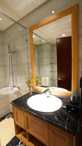 a bathroom with a sink and a large mirror at Saigon Aroma Hotel in Hanoi