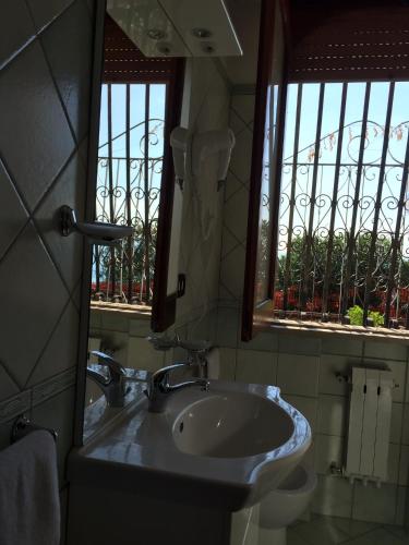 a bathroom with a sink and a mirror at Holiday Home Gionny & Mary in Taormina