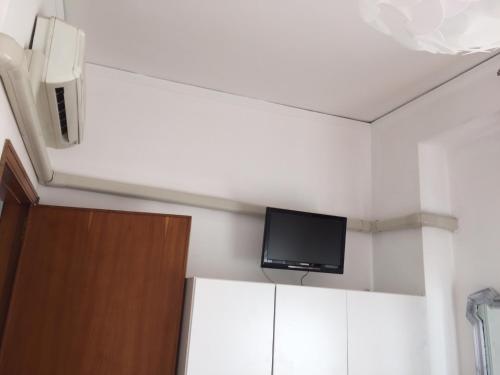 a room with a flat screen tv on the ceiling at Holiday Home Gionny & Mary in Taormina