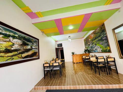a room with chairs and paintings on the walls at Sapa Harmony Homestay in Sapa