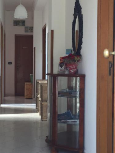 a mirror sitting on top of a wooden stand in a room at Holiday Home Gionny & Mary in Taormina